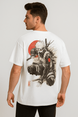Model wearing a white oversized t-shirt with a large anime samurai ninja print (Kakashi-inspired), red sun, and Japanese graphic details in streetwear style.