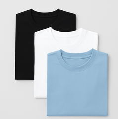 Three folded oversized cotton T-shirts in black, white, and sky blue—combo pack for unisex streetwear and minimalist style.