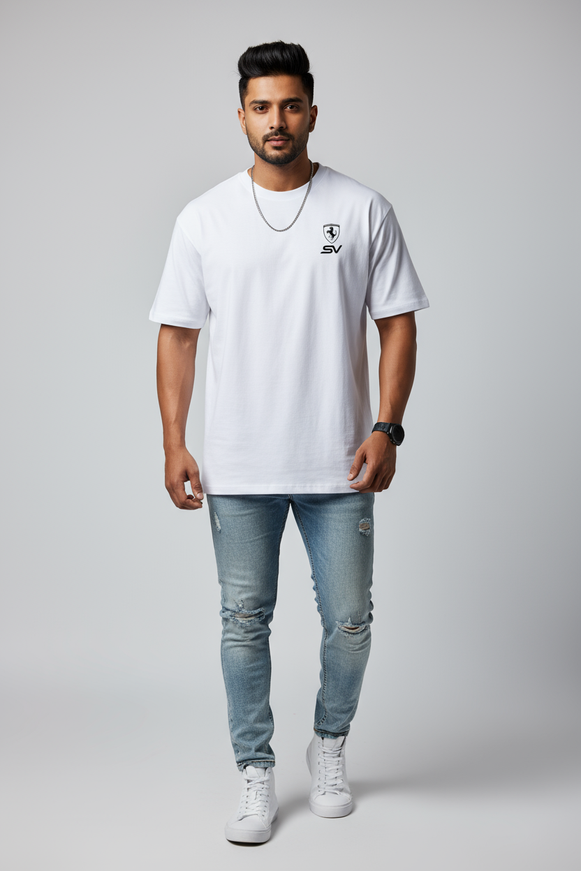 Man wearing a white t-shirt with a logo and light blue jeans on a gray background